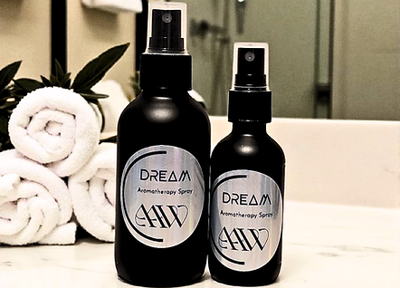 Dream Aromatherapy Spray image of both the 4oz and 2oz next to each other on bathroom countertop.