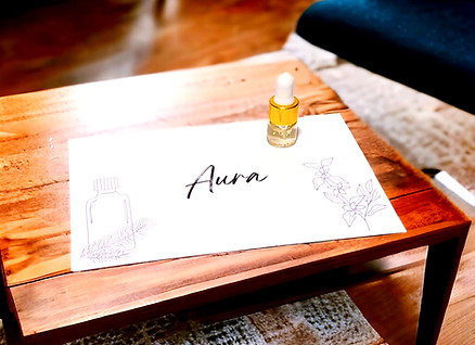 Aura Essential Oil Blend Sample 2ml on wood table.