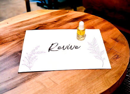 Revive Essential Oil Blend Sample 2ml on wood table.