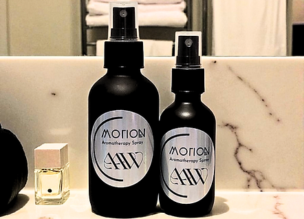 Motion Aromatherapy Spray image of both the 4oz and 2oz next to each other on bathroom countertop.