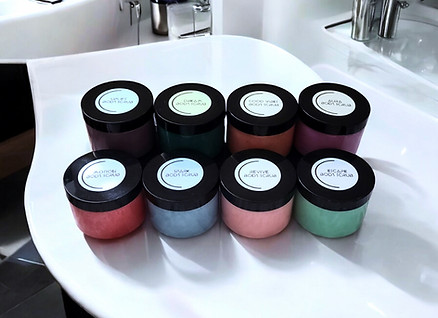Moisturizing Body Scrub Full Collection on bathroom countertop.