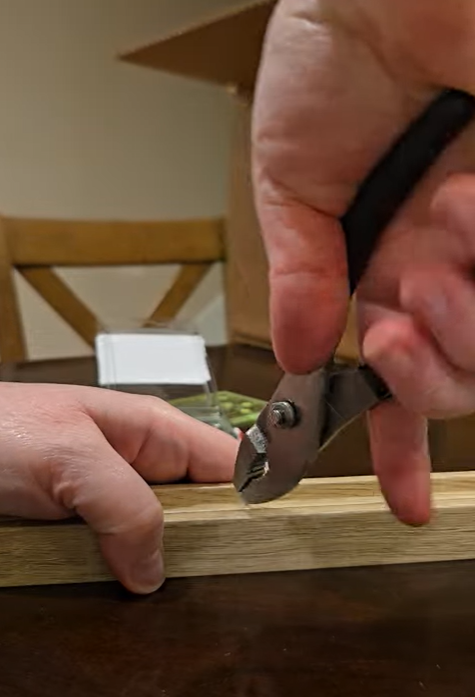 Installing screw eyes to the frame.