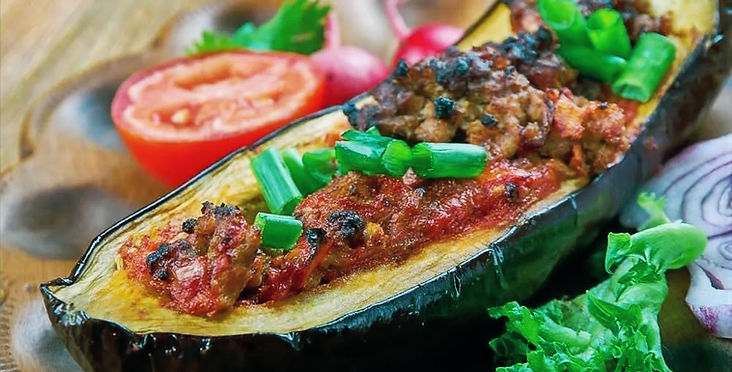 Stuffed half eggplant, with its fred and baked in garlic toato sauce , tpped by scallions.