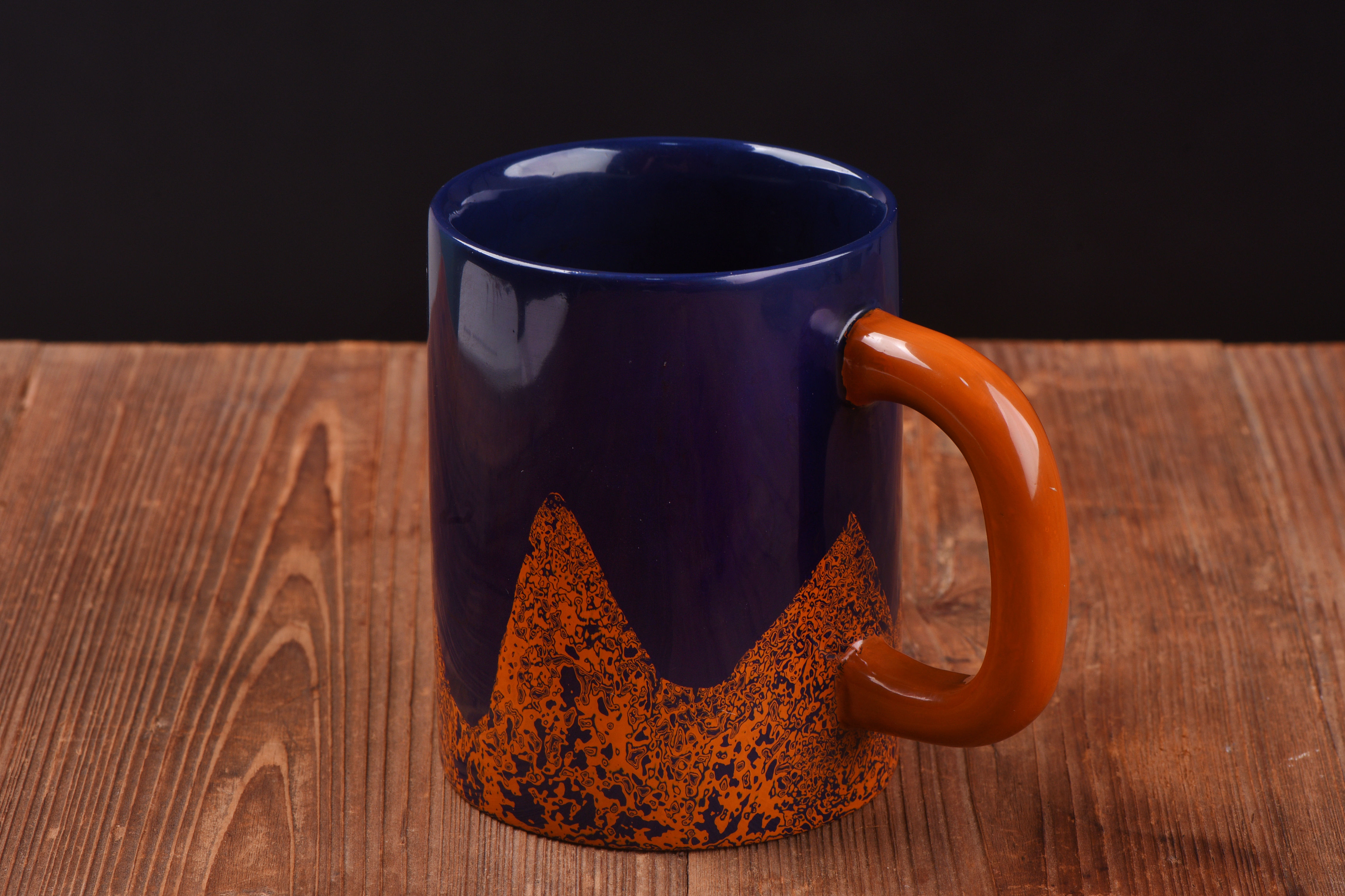 Blue and orange raw tree lacquer mug showing natural wavy texture