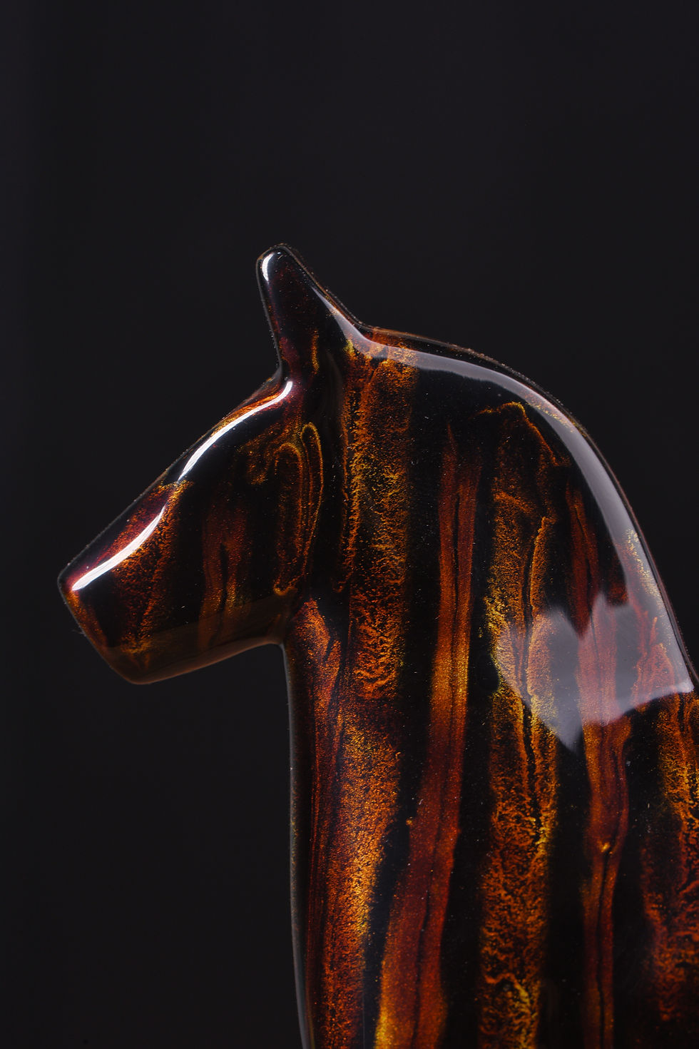 Close-up of flowing gold storm pattern on Dala horse neck
