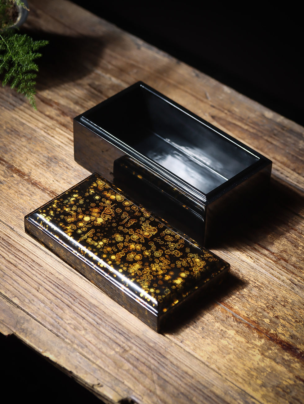 Flowing gold Chinese lacquer tiandigai box with gold lid and black base on wooden table, by HFDlacquerware