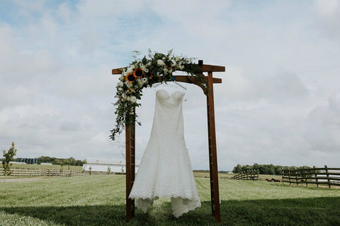dress and flower arch Blooms by Bri