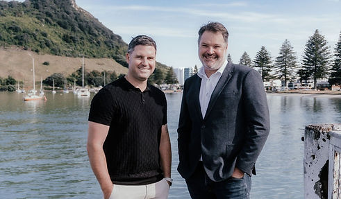 Two professional and friendly business coaches with a scenic backdrop