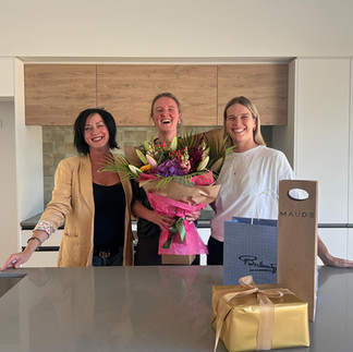 Hedgley Corporation team celebrating kitchen handover with new Christchurch homeowner after completing their custom home build