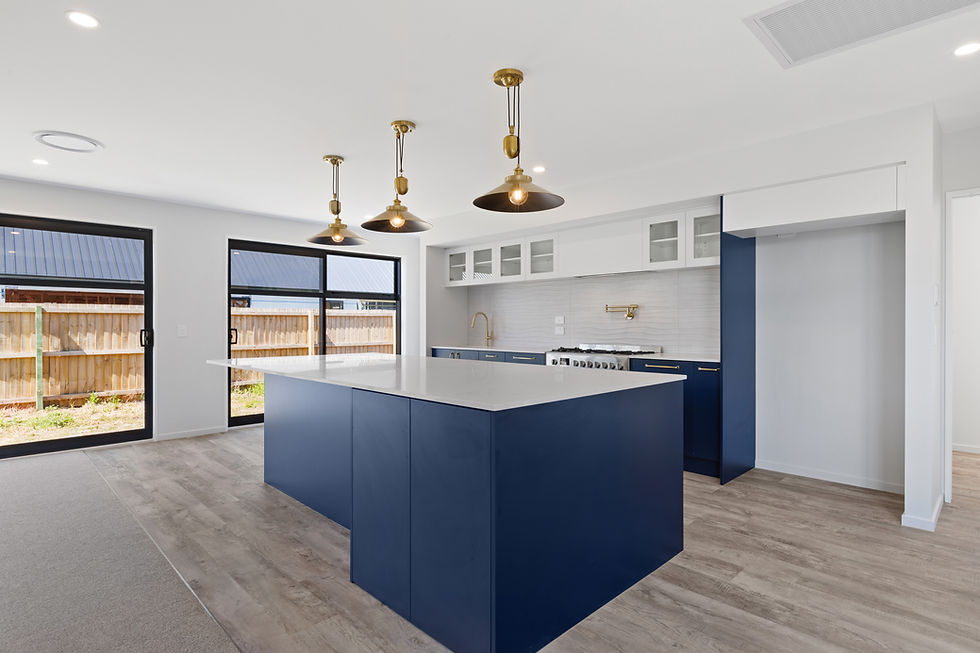 Modern kitchen with blue cabinetry and gold pendant lights designed by Kian Clements-Ormond, Hedgley Homes, New Zealand.