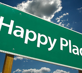 Happy Place Road Sign with dramatic blue sky and clouds.jpg