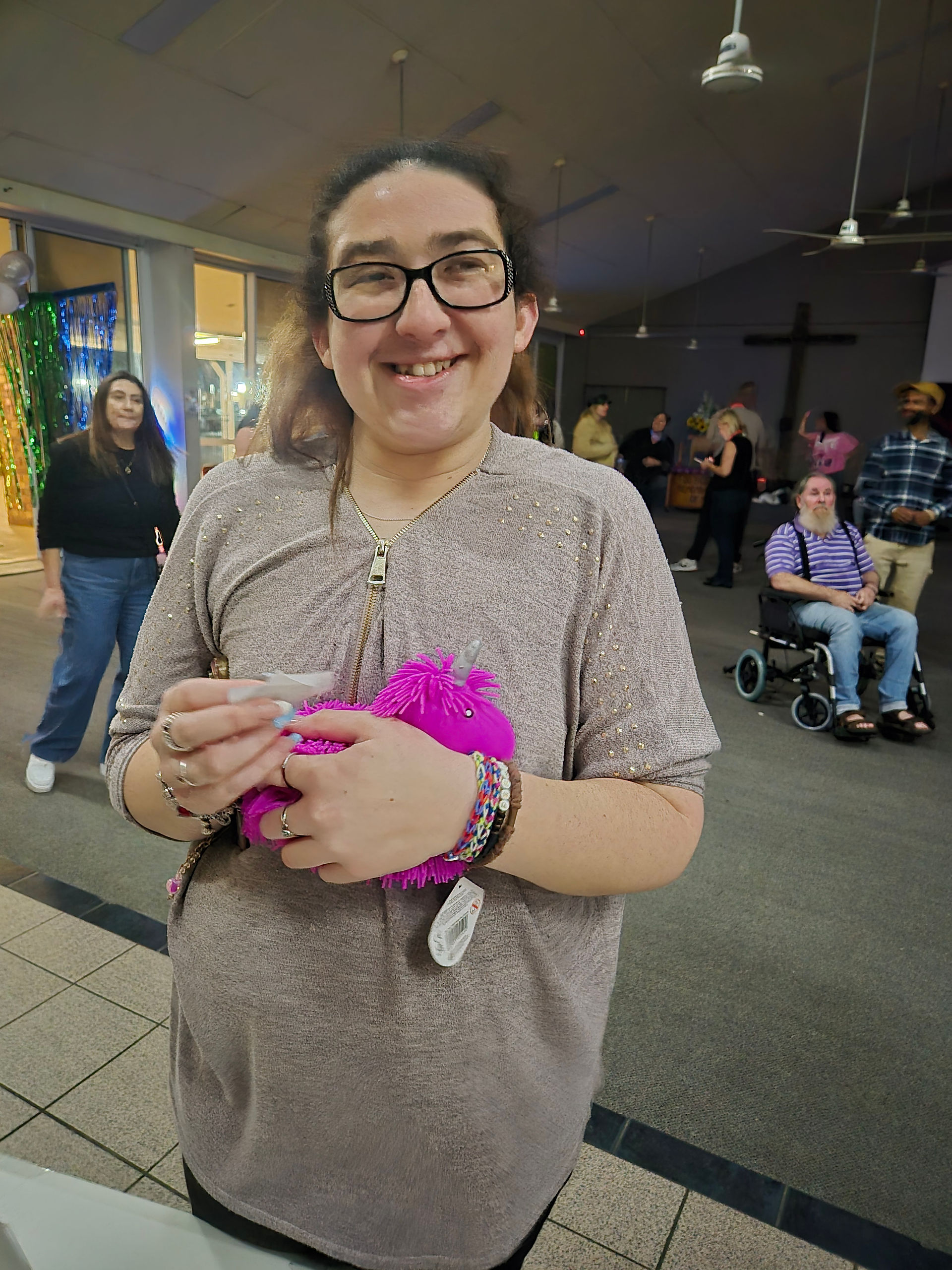 Participants holding their prizes at the DiscoAbility event
