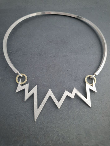 Bold choker collar with geometric zigzag design at its centre handmade in recycled sterling silver and 18 carat yellow gold. From jewellery designer Natalia McIntosh.