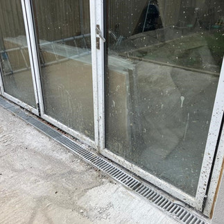 unprotected glass doors covered with construction dirt