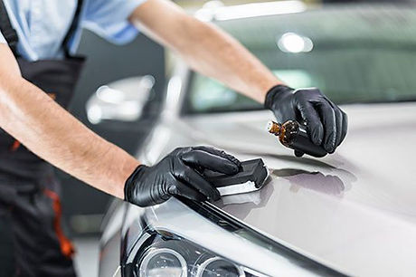 Man putting ceamic coatings on a car