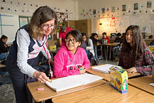 depositphotos_106174298-stock-photo-teacher-reading-book-with-class.jpg