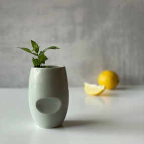 ceramic thumbprint cup, ice blue celadon glaze, mint garnish, lemon
