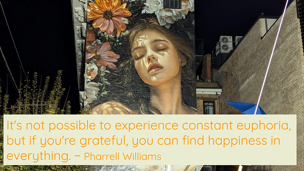 Quotepic Pharrell Williams on gratitude set against a Cincinnati Artworks mural of a woman eyes closed in happiness and gratitude