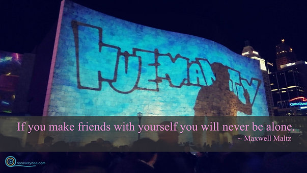 Quotepic Maxwell Maltz on being alone set against Artworks Huemanity Blink display on the Freedom Center in Cincinnati