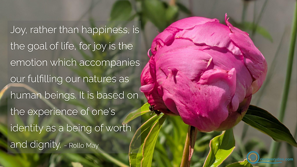 Quotepic Rollo May on joy set next to the tight bright pink bud of a peony