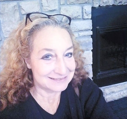 headshot, Dee Cloward by fireplace