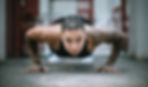 athlete looking at camera and doing a pushup