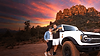 Nicole and Tony from Arabella Off Road standing next to their white bronco in Sedona with mountains in the background