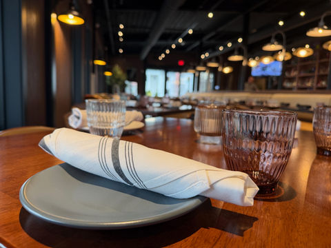 Table setting with plates and glassware inside Stratford Garden dining room