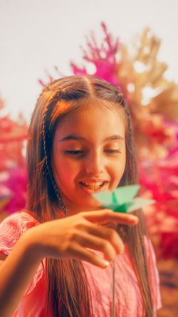Girl holding an origami butterfly in the King Salman Park paper world