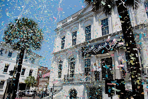 This is an image of the Spoleto Festival Opening with confetti falling in front of a white building.