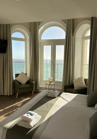Ocean view hotel room with large windows at The Clarence House Hotel, Tenby, Pembrokeshire.