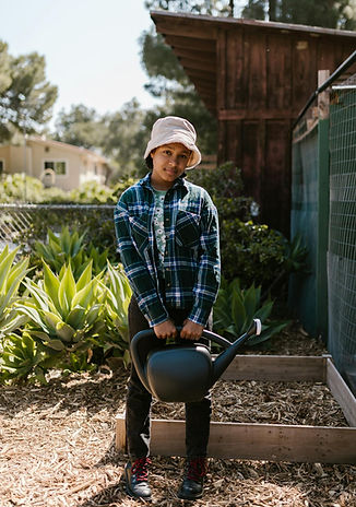 girl posing with farming tool
