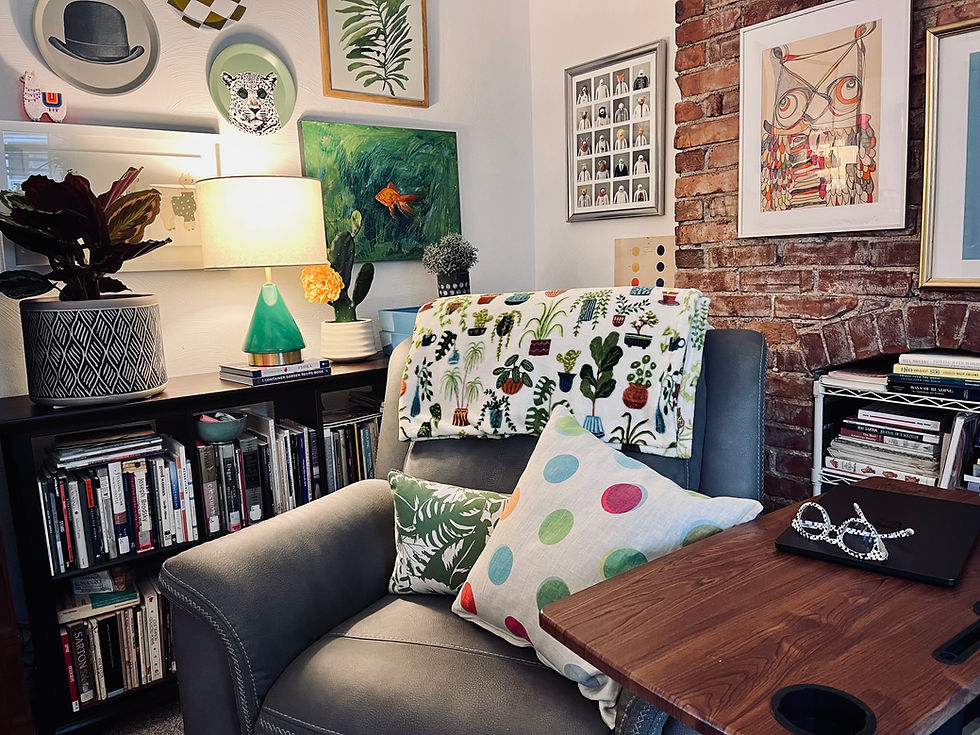 Writing desk with polka dot pillow and speckled reading glasses
