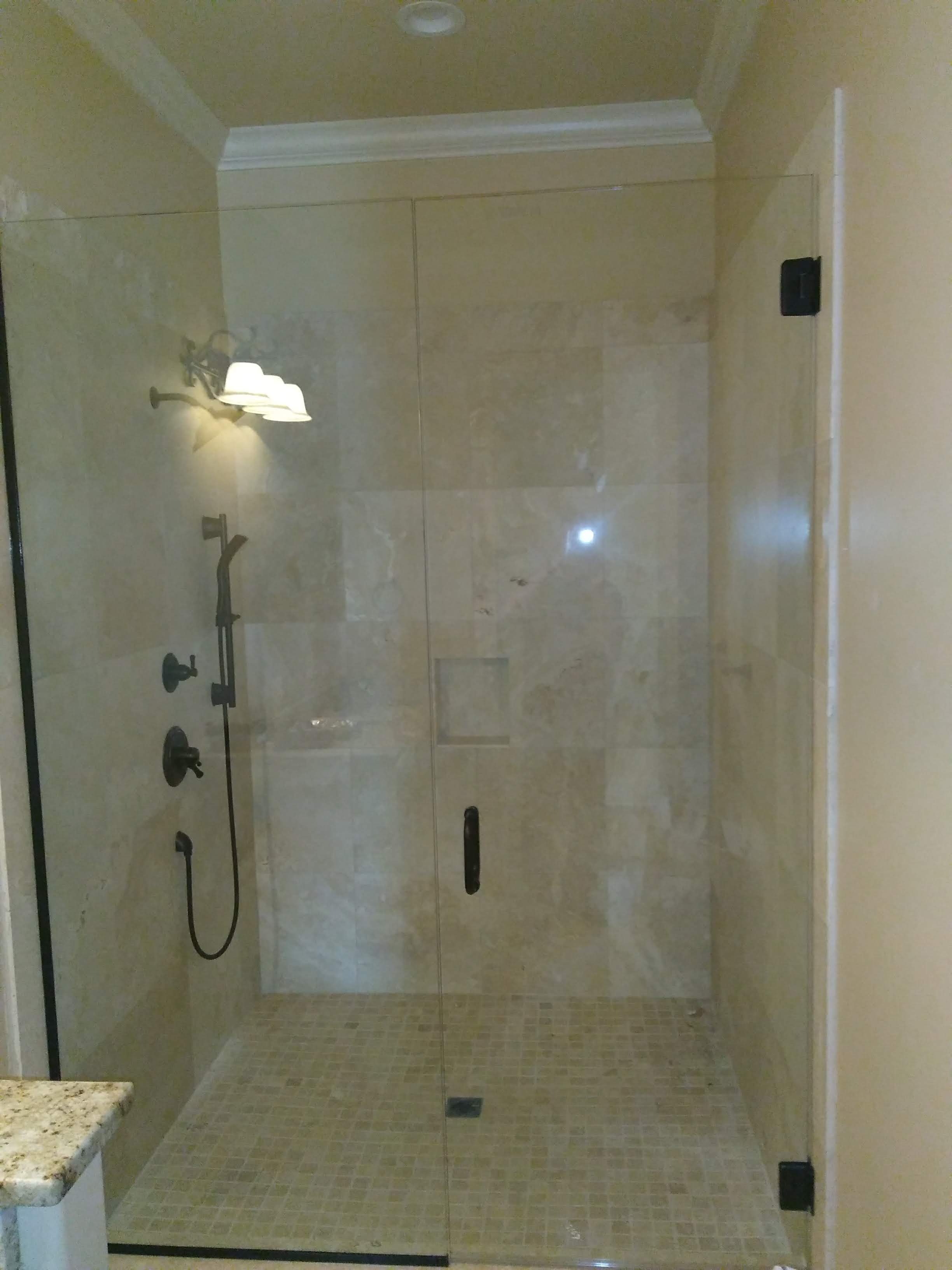 Frameless shower enclosure