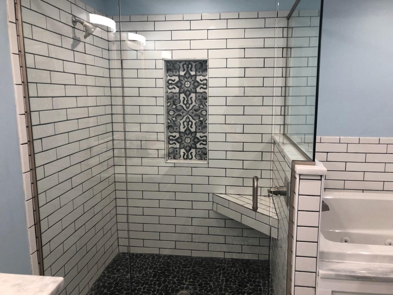 Frameless shower enclosure