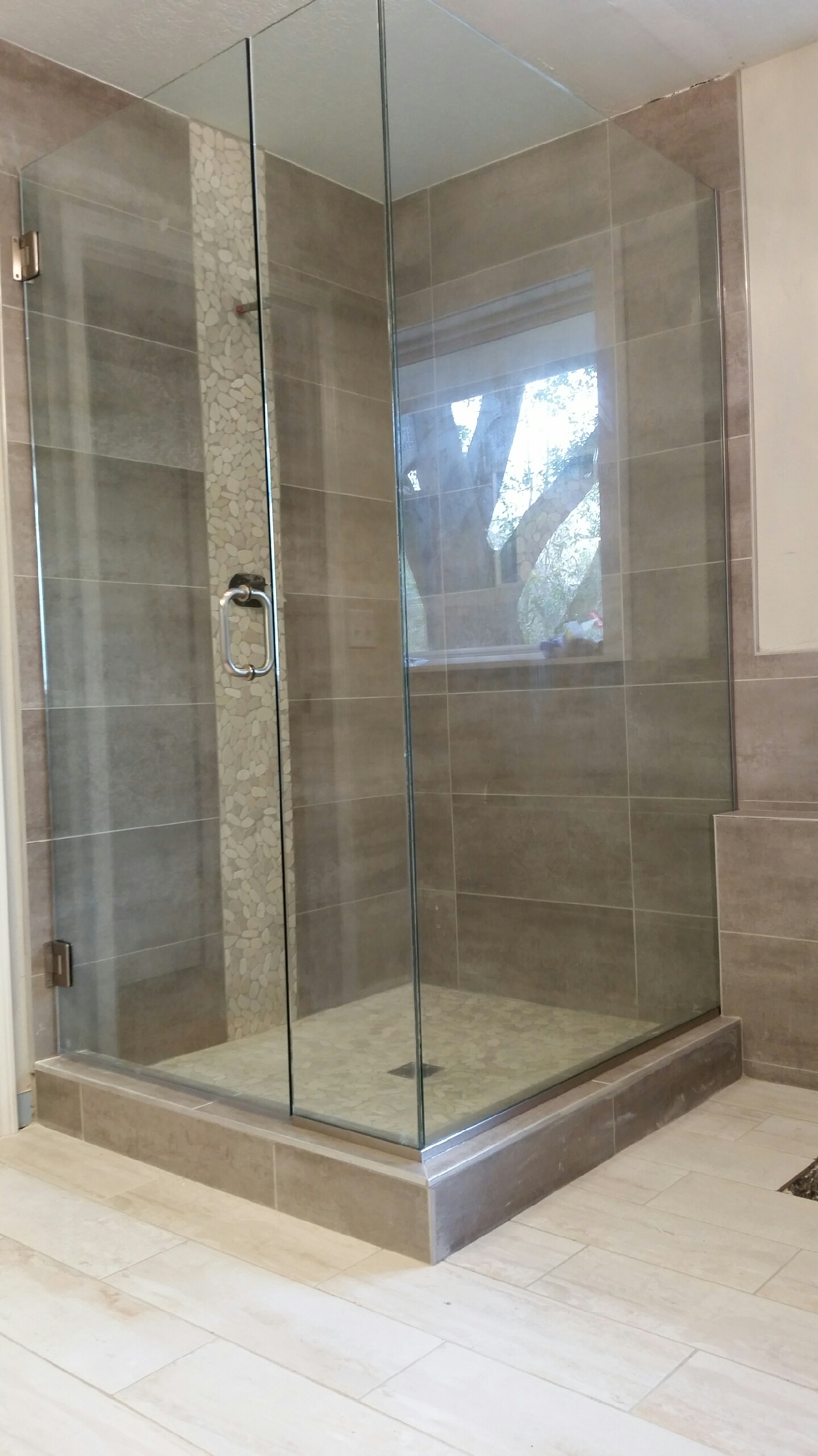 Frameless hinged shower enclosure