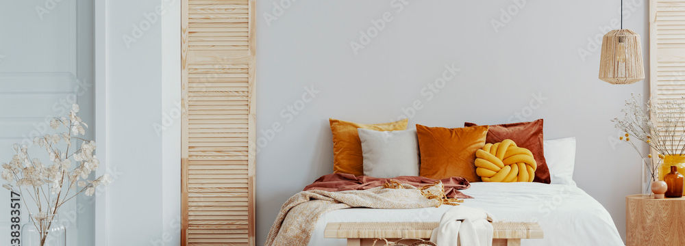 Bed with orange pillows and white bedding