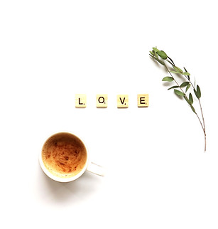 cup of coffee on white background with foliage