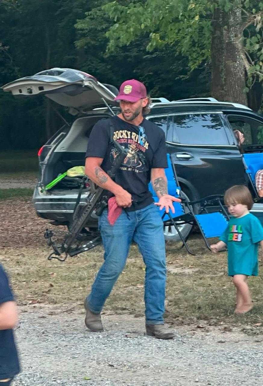 Dustin holding the crossbow at Rocky River Resort.