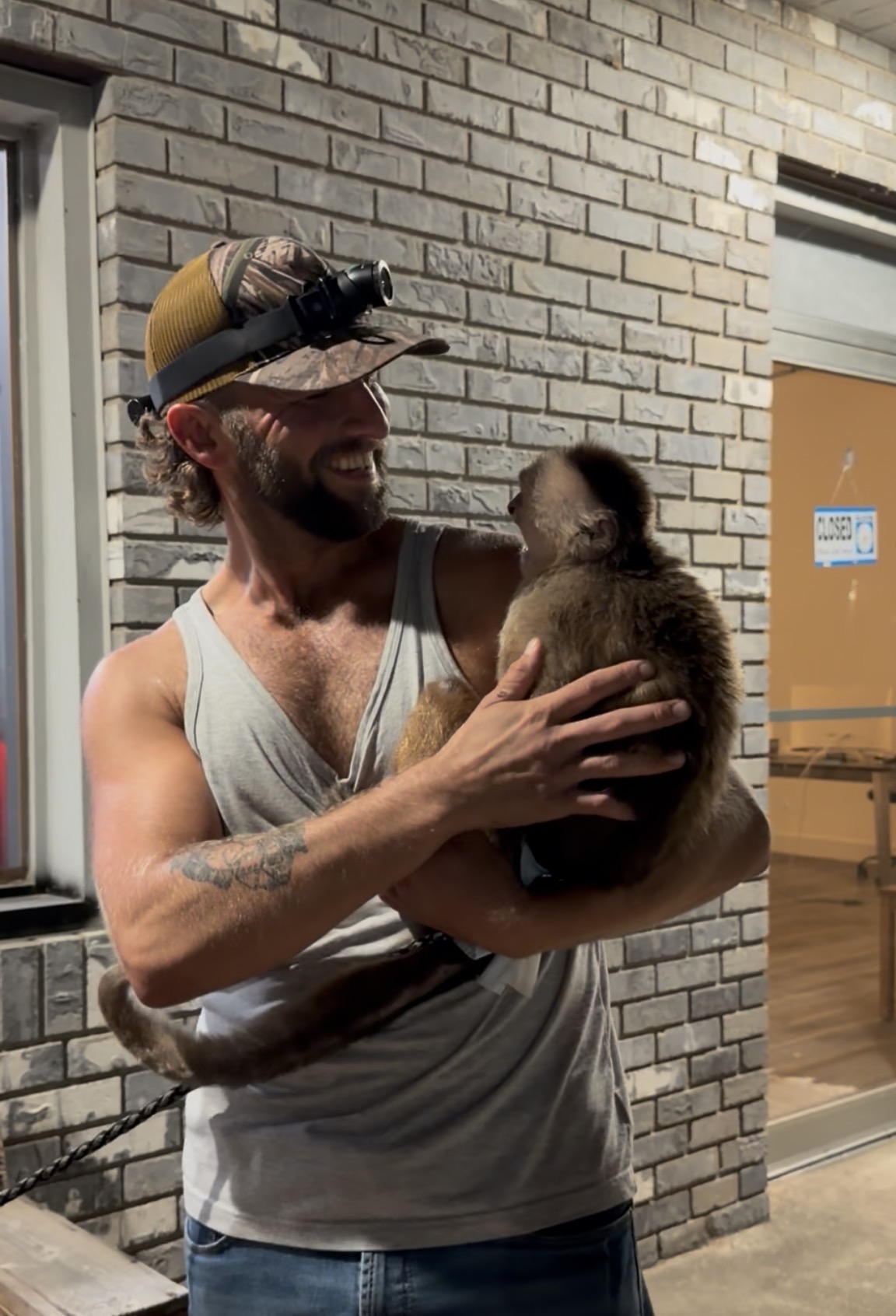 Holding the monkey during the tattoo-shop visit.