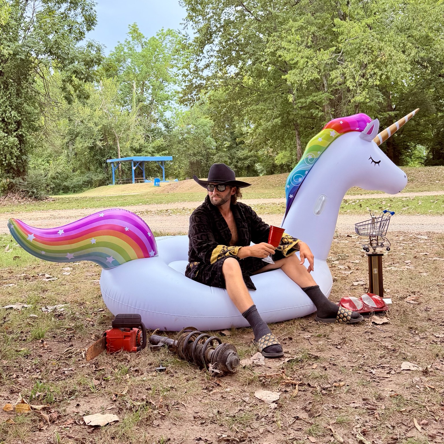 Dustin dressed up and seated on Dolly the inflatable unicorn.