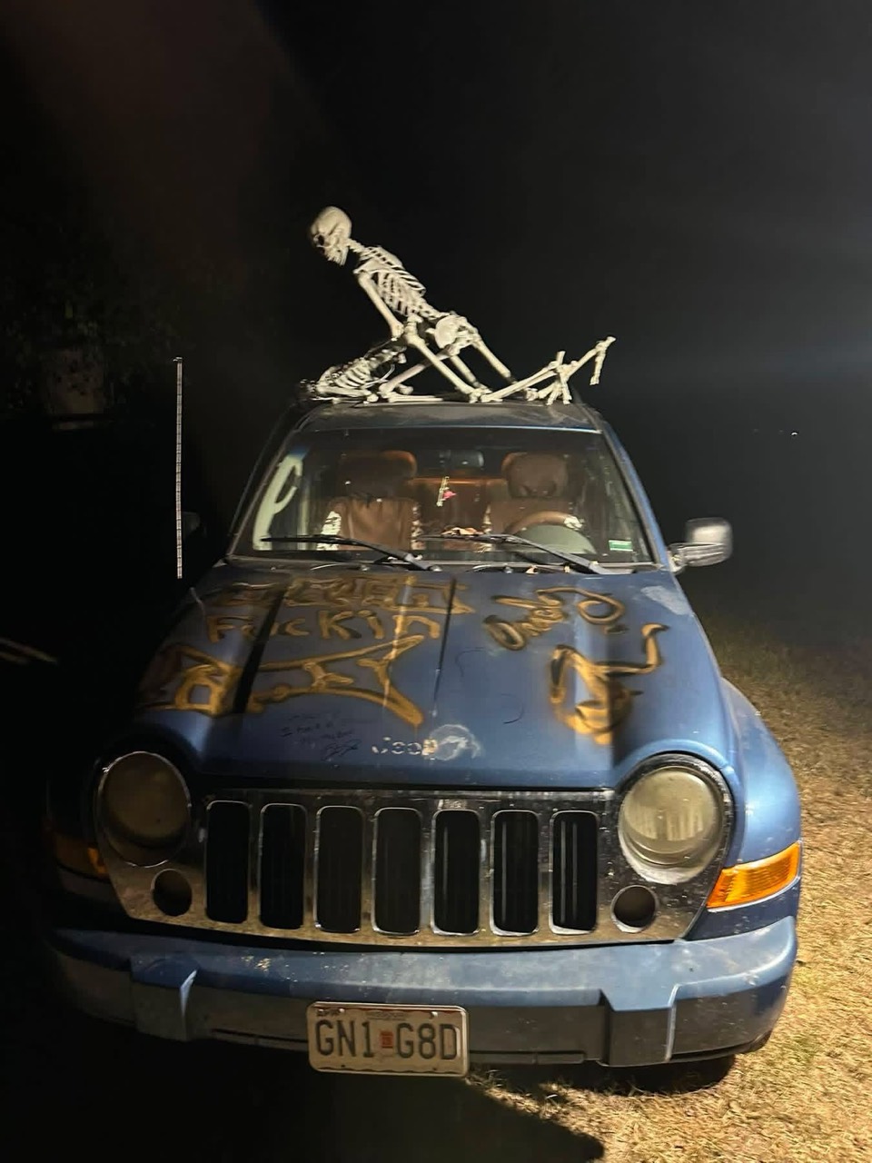 The spray-painted hood of Cheyenne’s Jeep, with skeletons posed on the roof.