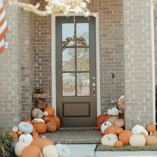 Fall pumpkins lined up along the homes entryway