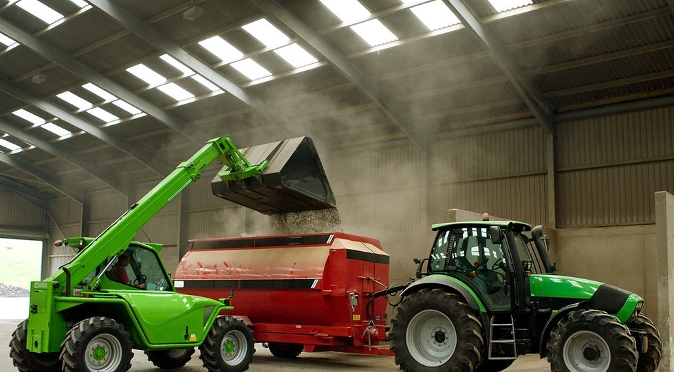 Construction vehicles offloading soil into trailer