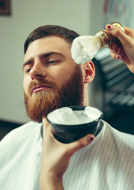 client-during-beard-shaving-in-barbersho