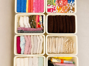 Organized fabric pieces in small storage containers.