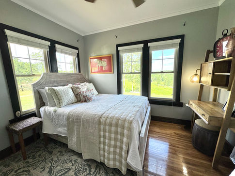 Poppy's Corner Bedroom with two queen beds and cozy decor at Rock Creek Venue.