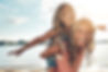 Portrait, mother and child on beach with piggyback, smile and playing on adventure holiday
