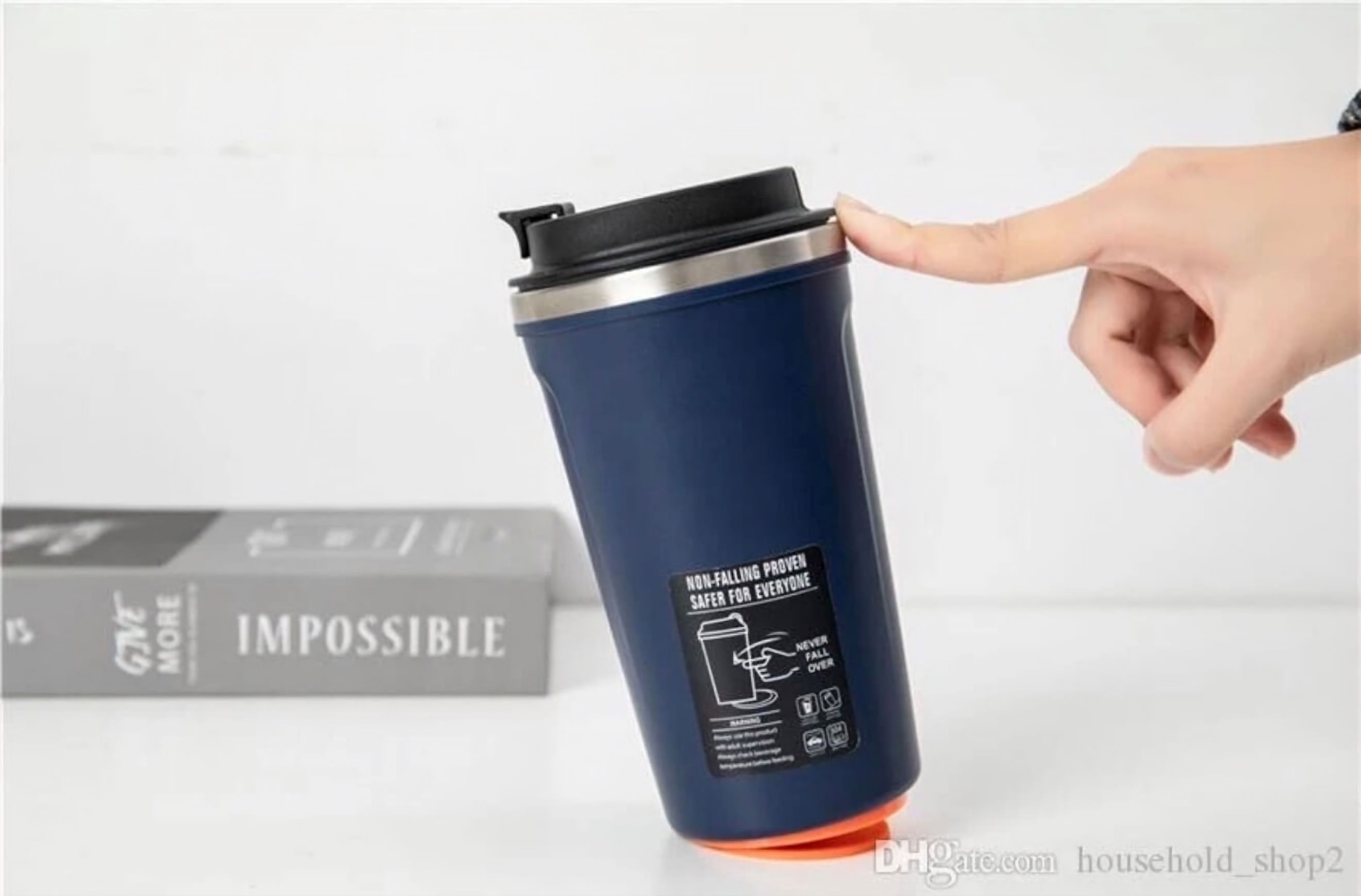 Hand pressing lid on blue travel mug