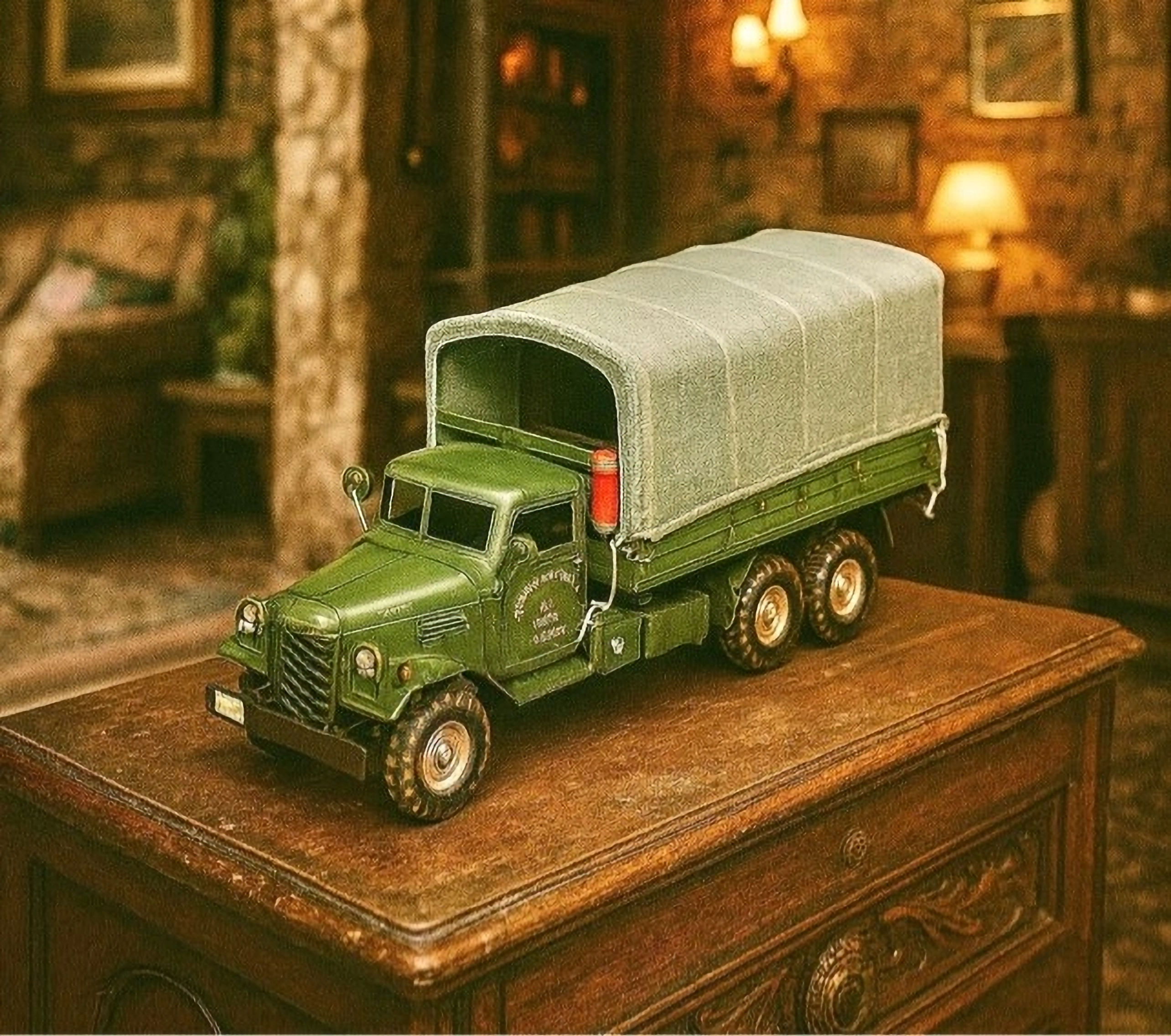 Green vintage toy truck with canvas top on wood table